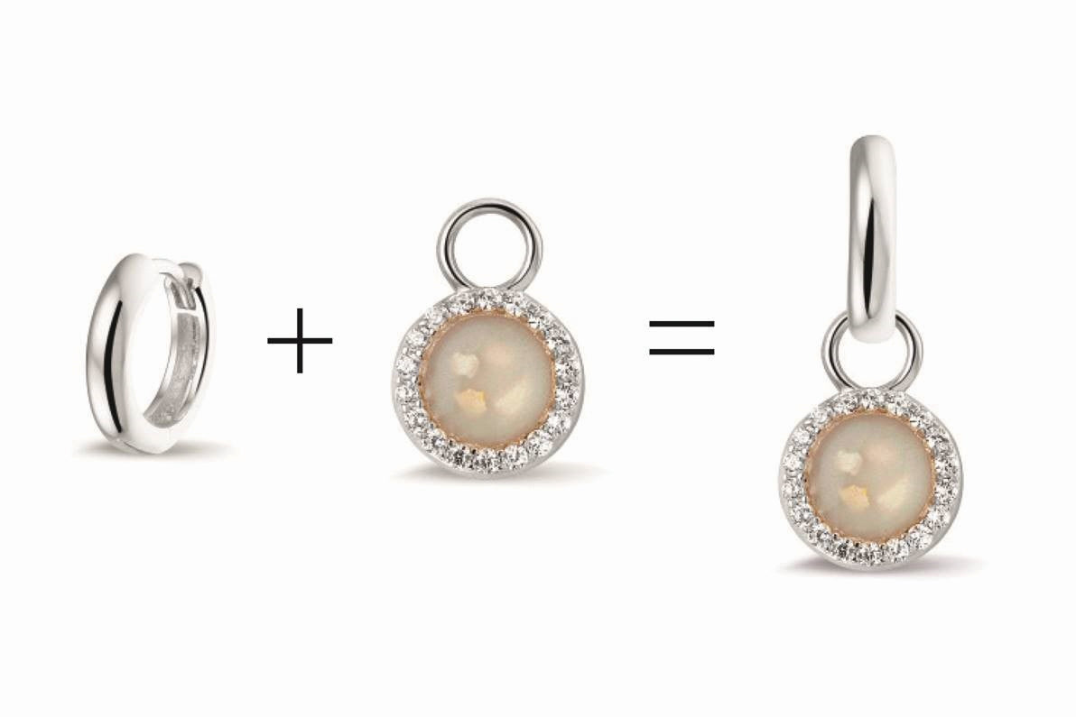 Oorhangers 8 mm diameter, rondom afgewerkt met zirkonia's, aan de voorzijde zichtbaar gevuld met as of haar. alle
