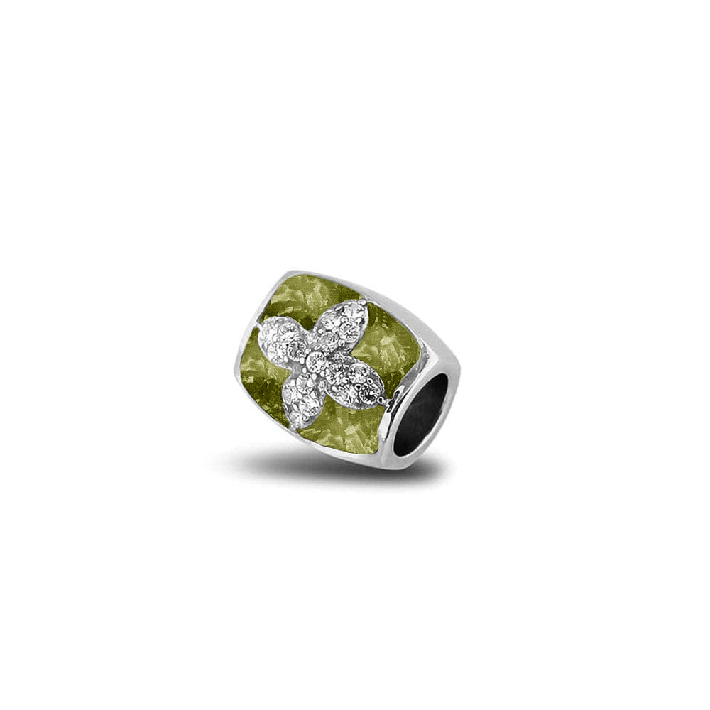 Asbedel met  zirkonia's, aan beide zijdes in twee compartimenten zichtbaar gevuld met as of haar. Olive