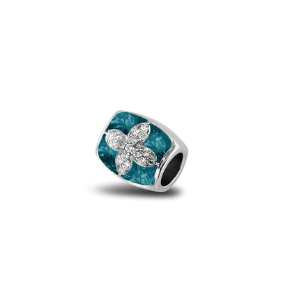 Asbedel met  zirkonia's, aan beide zijdes in twee compartimenten zichtbaar gevuld met as of haar. Turquoise