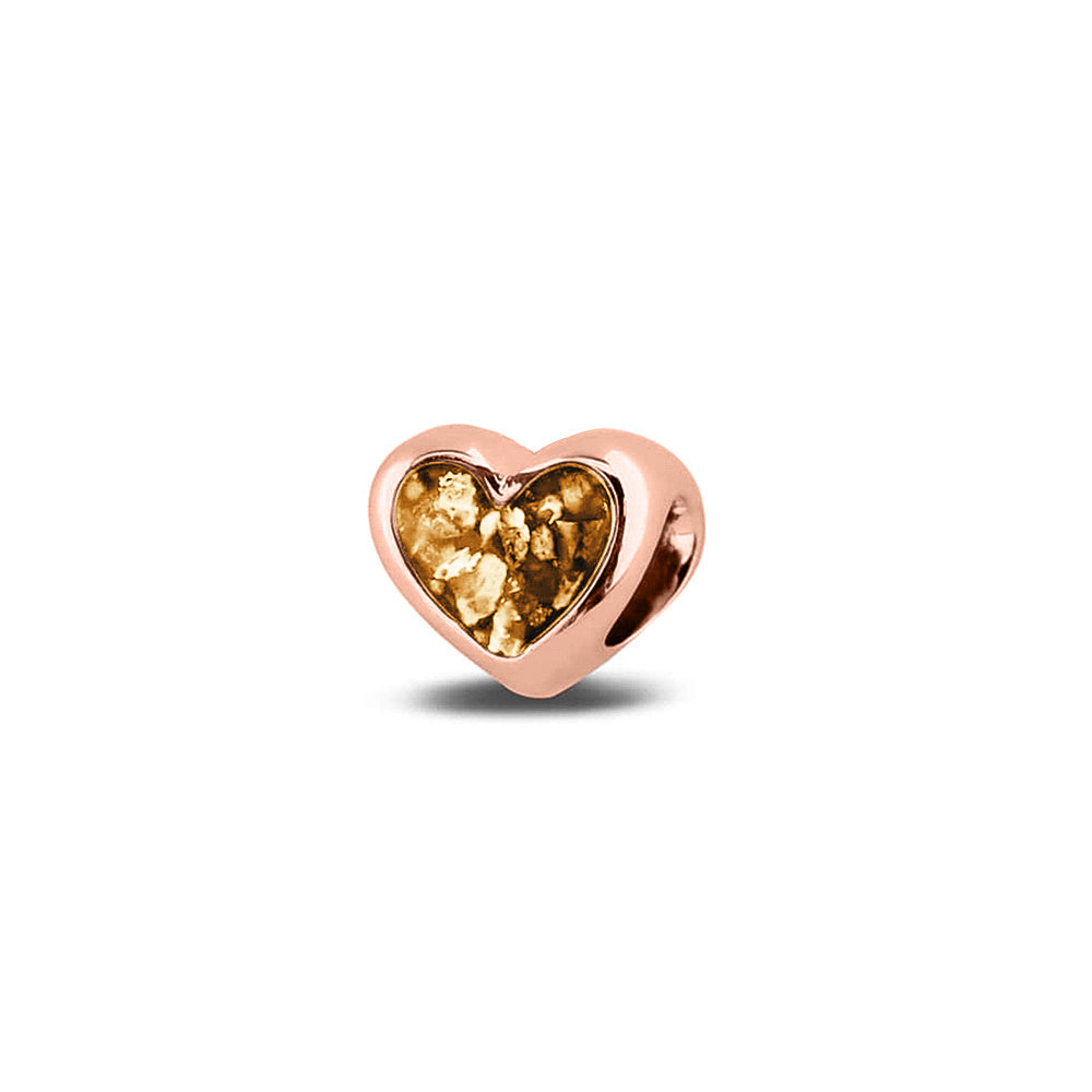 Hartvormige asbedel, aan beide zijdes zichtbaar gevuld met as of haar. Het vullen en sealen met onze speciale hars met een keuze in 20 kleuren, wordt in onze ambachtelijke edelsmederij gedaan. Gold