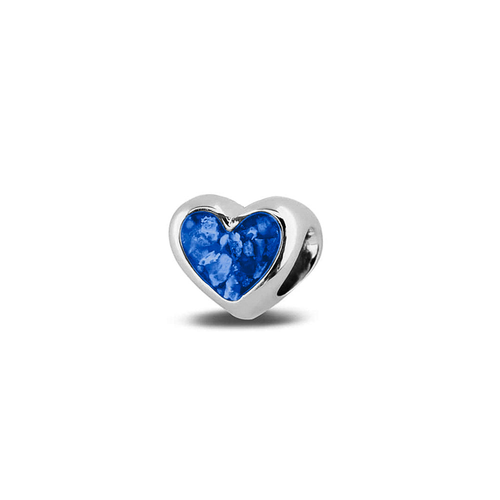Hartvormige asbedel, aan beide zijdes zichtbaar gevuld met as of haar. Het vullen en sealen met onze speciale hars met een keuze in 20 kleuren, wordt in onze ambachtelijke edelsmederij gedaan. Blue