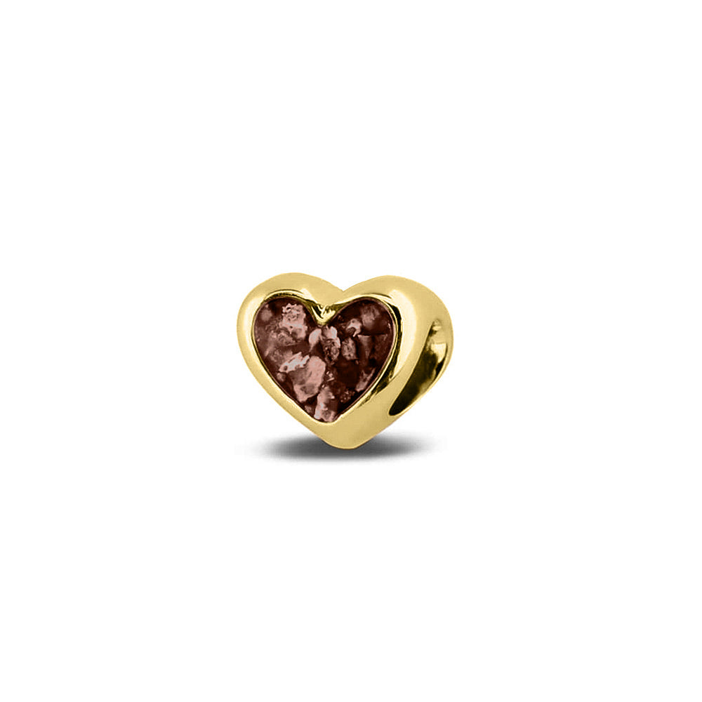 Hartvormige asbedel, aan beide zijdes zichtbaar gevuld met as of haar. Het vullen en sealen met onze speciale hars met een keuze in 20 kleuren, wordt in onze ambachtelijke edelsmederij gedaan. Brown
