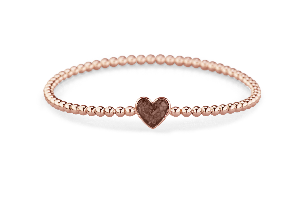 Flexibele as armband met hart als compartiment voor as of haar, gedenksieraden. Brown