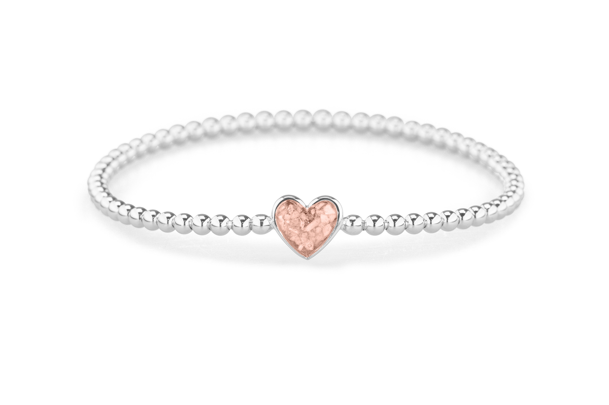 Flexibele as armband met hart als compartiment voor as of haar, gedenksieraden. Blush