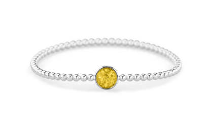 Flexibele as armband met rondje als compartiment voor as of haar, gedenksieraden. Yellow