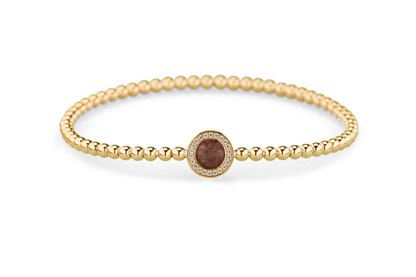 Flexibele as armband met rondje als compartiment gezet rondom met zirconia's voor as of haar. Brown