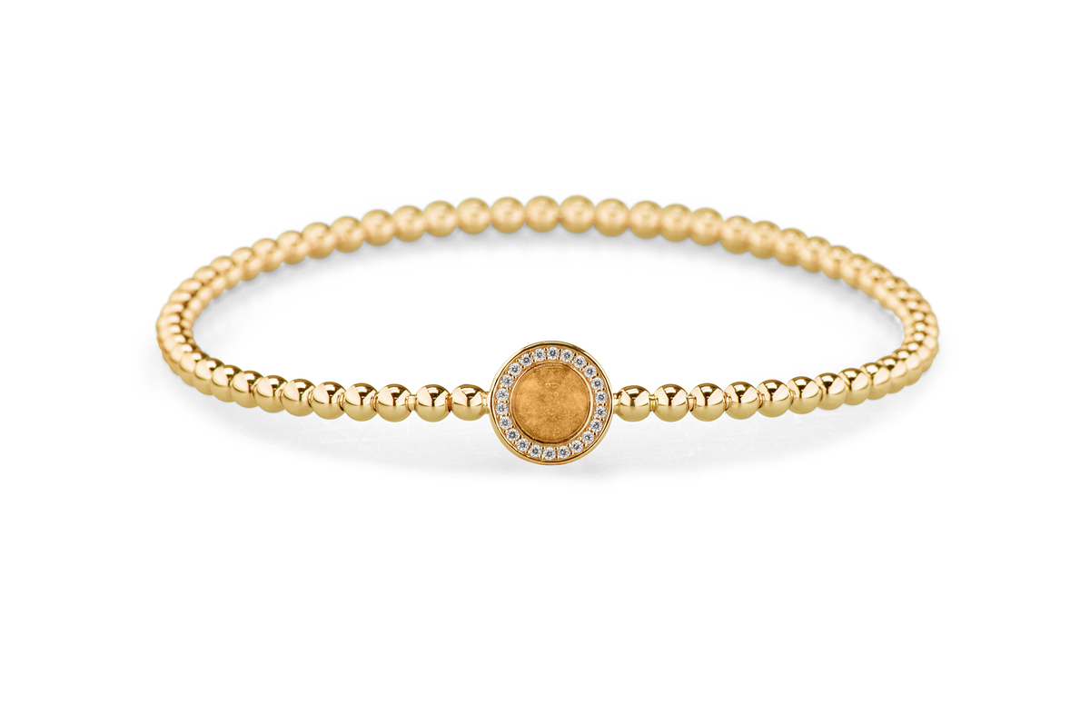 Flexibele as armband met rondje als compartiment gezet rondom met zirconia's voor as of haar. Gold