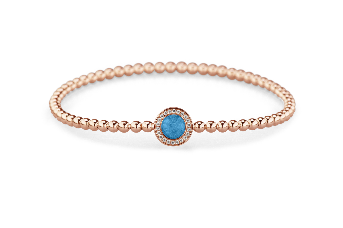 Flexibele as armband met rondje als compartiment gezet rondom met zirconia's voor as of haar. Marine
