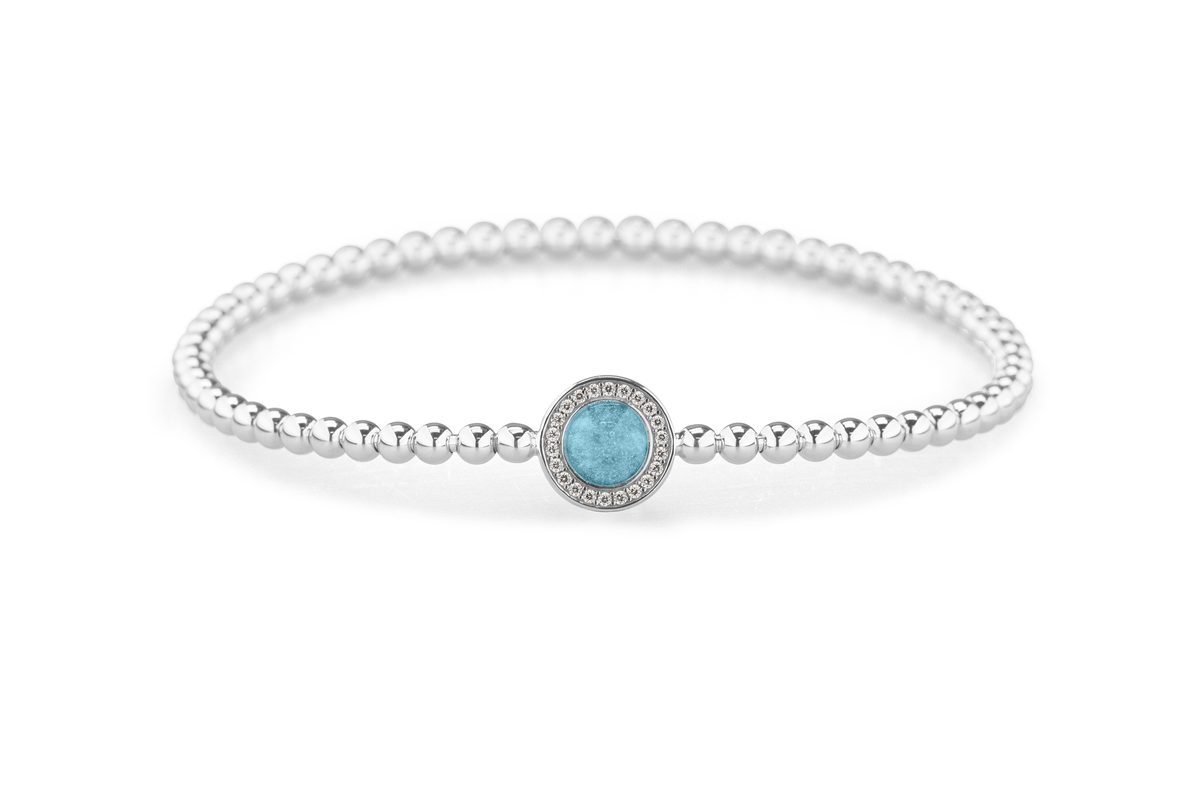 Flexibele as armband met rondje als compartiment gezet rondom met zirconia's voor as of haar. Baby